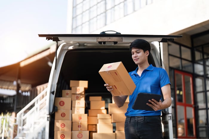 asian-courier-with-parcel-and-delivery-logistic-co-2023-04-04-18-24-36-utc