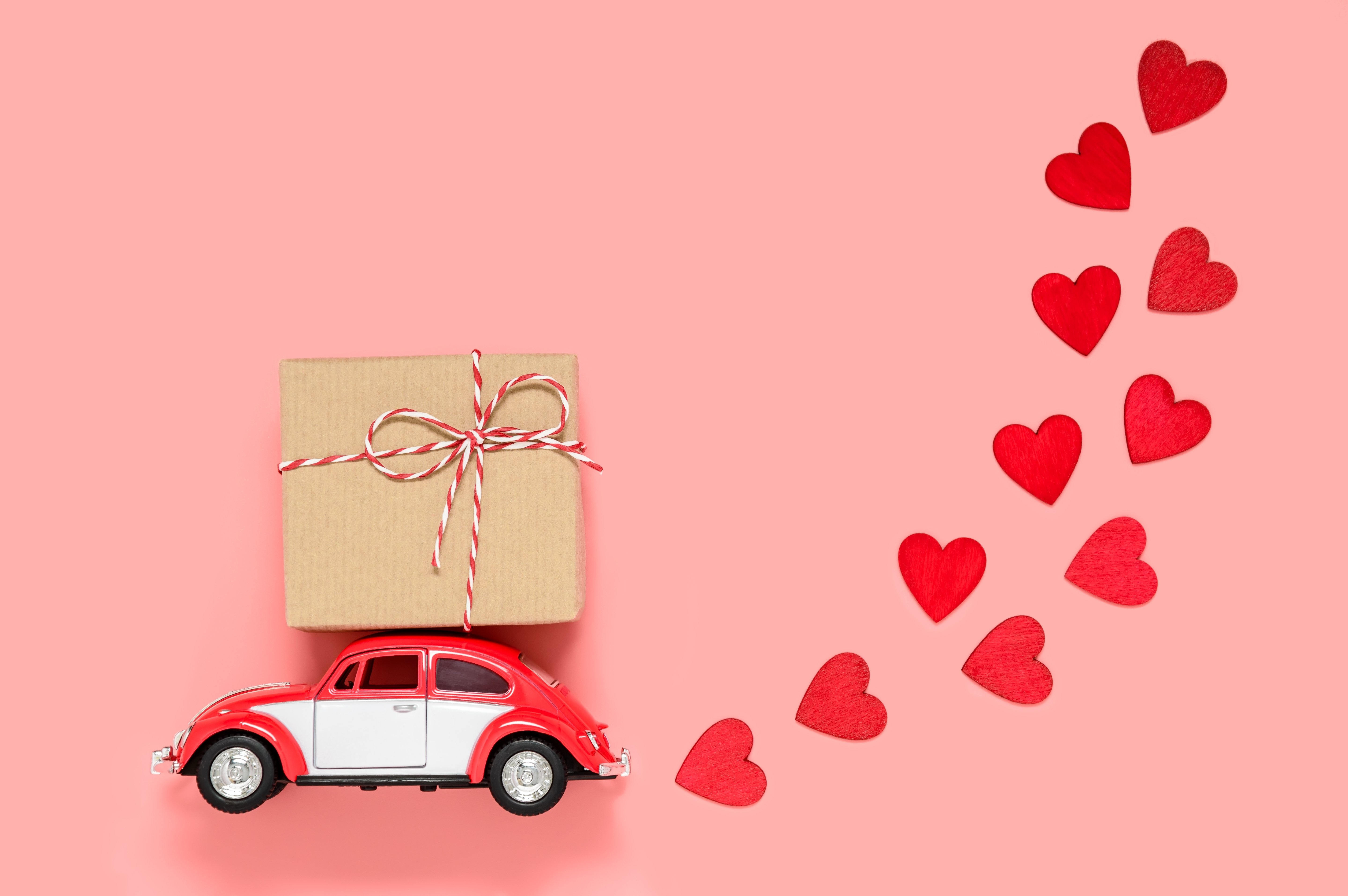 small-red-retro-toy-car-delivering-gift-box-for-va-2022-11-16-18-09-42-utc